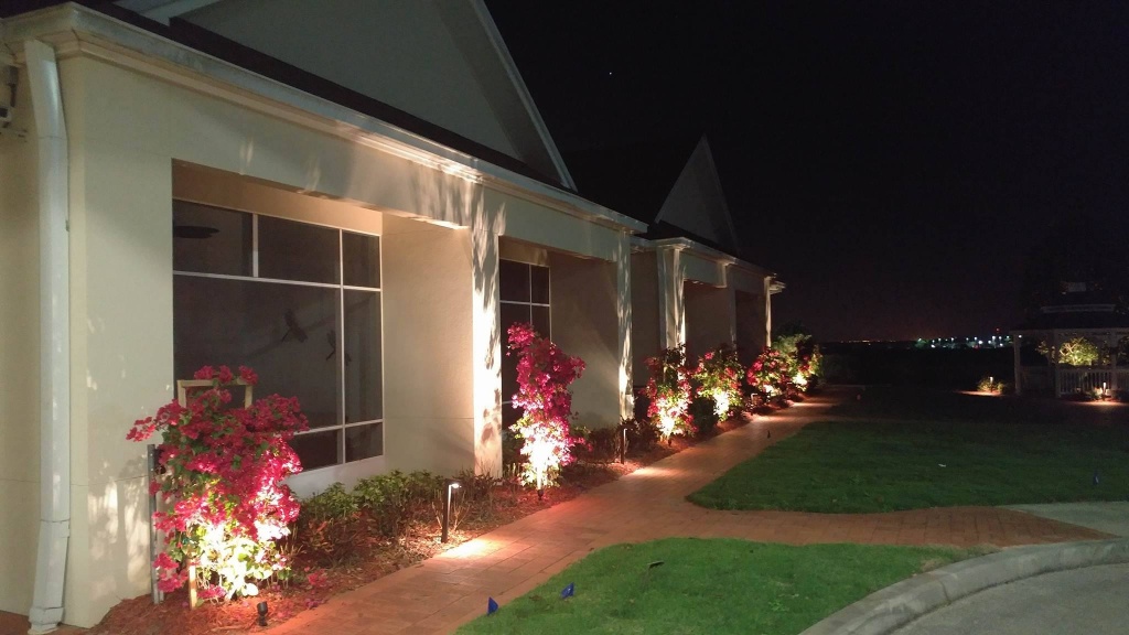 Architectural landscape lighting along a home exterior at night
