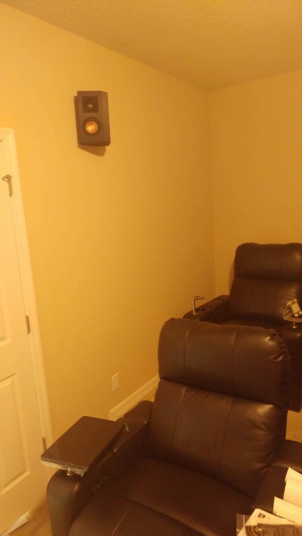 Dedicated home theater seating with an in-wall surround speaker