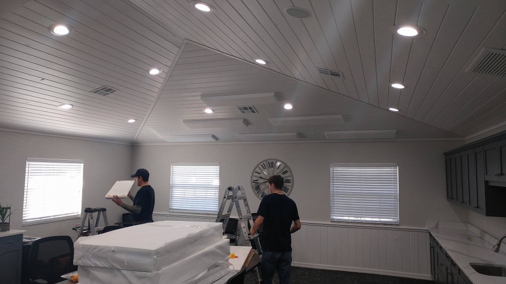 Acoustic treatment panels installed in a commercial ceiling