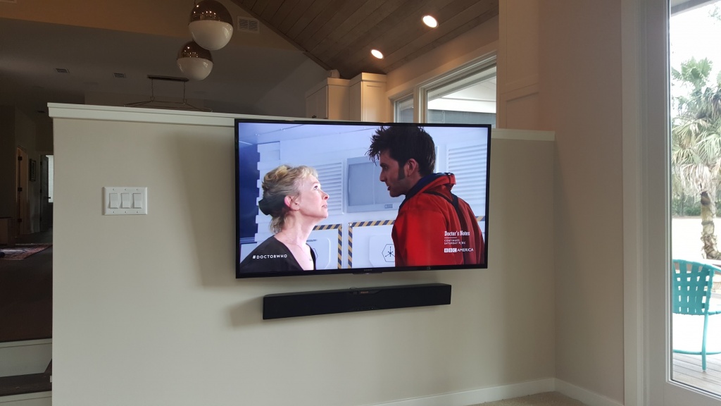 Living room television mounted above a stone accent wall